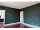 A spacious bedroom with green walls and decorative wood floors at 1121 Myrtle Ave # 17, Charlotte, NC 28203
