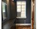 A neutral bedroom with a vintage-style mirror and decorative wood floors at 1121 Myrtle Ave # 17, Charlotte, NC 28203