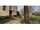 A pathway leads to well-maintained apartment building with mature landscaping at 1121 Myrtle Ave # 17, Charlotte, NC 28203