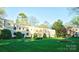 Beautiful exterior of the two-story building with manicured lawn and mature trees at 1121 Myrtle Ave # 17, Charlotte, NC 28203