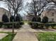 A landscaped walkway with hedges and greenery leads to apartment homes at 1121 Myrtle Ave # 17, Charlotte, NC 28203