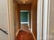 A long hallway showcases decorative wood floors and access to other rooms at 1121 Myrtle Ave # 17, Charlotte, NC 28203