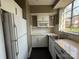 A clean, compact kitchen with white cabinets, subway tile, and stainless steel appliances at 1121 Myrtle Ave # 17, Charlotte, NC 28203