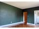 Living room view showcasing green walls, decorative floors, and access to the kitchen at 1121 Myrtle Ave # 17, Charlotte, NC 28203
