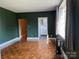 Bright living room featuring hardwood floors, dark green painted walls, and ample natural light at 1121 Myrtle Ave # 17, Charlotte, NC 28203