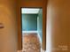A view of the large living room showcasing green walls and decorative wood floors at 1121 Myrtle Ave # 17, Charlotte, NC 28203