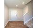 Welcoming entryway with wood-look flooring and a staircase leading to the upper level at 12128 Lady Bell Dr, Charlotte, NC 28278