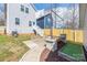 Backyard featuring a stone firepit, wooden pergola, and steps leading up to the house at 12304 Huntersville Concord Rd, Huntersville, NC 28078
