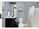 Simple bathroom with white fixtures, a black vanity, and neutral wall color at 12304 Huntersville Concord Rd, Huntersville, NC 28078