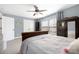 Bright bedroom with a wooden armoire, large windows, and soft blue accents at 12304 Huntersville Concord Rd, Huntersville, NC 28078