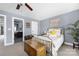 Comfortable bedroom with a decorative metal bed frame and attached bathroom at 12304 Huntersville Concord Rd, Huntersville, NC 28078