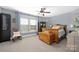 Charming bedroom with a vintage wood bed frame, rocking chair, and ample natural light at 12304 Huntersville Concord Rd, Huntersville, NC 28078
