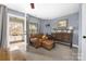 Comfortable bedroom features a leather chair, and porch access at 12304 Huntersville Concord Rd, Huntersville, NC 28078