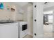 Convenient laundry room with modern washer, dryer, and storage shelving at 12304 Huntersville Concord Rd, Huntersville, NC 28078