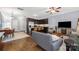 Open concept living and dining area with modern furnishings and stainless steel kitchen appliances at 12304 Huntersville Concord Rd, Huntersville, NC 28078