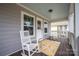 Charming covered porch with rocking chairs and a stylish patterned rug at 12304 Huntersville Concord Rd, Huntersville, NC 28078