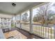 Spacious porch with white railings and chairs, perfect for enjoying the neighborhood views at 12304 Huntersville Concord Rd, Huntersville, NC 28078