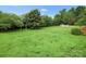 Expansive backyard featuring lush lawn, mature trees and wooden fence, creating an inviting outdoor space at 1278 Gracebrook Dr, Salisbury, NC 28147