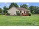 The rear exterior of the home with a wooden deck, lush lawn and privacy fence at 1278 Gracebrook Dr, Salisbury, NC 28147