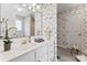 Charming bathroom featuring a white single sink vanity and floral wallpaper at 1278 Gracebrook Dr, Salisbury, NC 28147