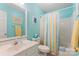Bright bathroom with blue walls, white vanity, and colorful shower curtain at 1278 Gracebrook Dr, Salisbury, NC 28147