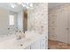 Bathroom with a white sink vanity, mirror, and floral wallpaper at 1278 Gracebrook Dr, Salisbury, NC 28147