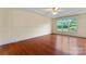 Bright bedroom featuring a tray ceiling, hardwood floors, and large window with natural light at 1278 Gracebrook Dr, Salisbury, NC 28147