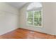 Empty bedroom featuring hardwood floors and a window with natural light and a closet shelf at 1278 Gracebrook Dr, Salisbury, NC 28147