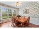 Cozy dining room featuring a traditional wooden table, floral wallpaper, and bright natural light at 1278 Gracebrook Dr, Salisbury, NC 28147