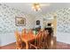 Classic dining room showcasing a wooden table and floral wallpaper, adjacent to living area at 1278 Gracebrook Dr, Salisbury, NC 28147