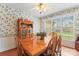 Charming dining room with a wooden table and chairs, surrounded by floral wallpaper at 1278 Gracebrook Dr, Salisbury, NC 28147