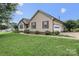 Tan home featuring attached garage and mature landscaping with a sidewalk leading to the front entrance at 1278 Gracebrook Dr, Salisbury, NC 28147