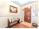 Inviting foyer features a wooden bench with pillows, a mirror, and a classic wooden front door at 1278 Gracebrook Dr, Salisbury, NC 28147