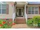 Charming entrance with brick steps, white railings, and plants, creating a welcoming curb appeal at 1278 Gracebrook Dr, Salisbury, NC 28147