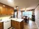 Functional kitchen with traditional wooden cabinets, white countertops, and a view into the dining area at 1278 Gracebrook Dr, Salisbury, NC 28147
