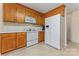 Traditional eat-in kitchen features oak cabinets, white appliances, and vinyl flooring at 1278 Gracebrook Dr, Salisbury, NC 28147