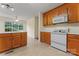 A functional kitchen with wooden cabinets, white appliances, and lots of counterspace; bright with natural light at 1278 Gracebrook Dr, Salisbury, NC 28147