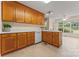 A well lit kitchen featuring wooden cabinets and a view of the outdoors perfect for cooking and gathering at 1278 Gracebrook Dr, Salisbury, NC 28147