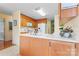 Open kitchen with a double sink, wood cabinets, and natural light from the adjacent door at 1278 Gracebrook Dr, Salisbury, NC 28147