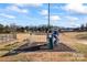 Community playground with colorful play equipment, swings, and seating area surrounded by lush green space at 1278 Gracebrook Dr, Salisbury, NC 28147
