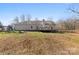 Expansive backyard featuring a deck and a playground, perfect for outdoor entertainment and Gathering fun at 1298 Hines Rd, Clover, SC 29710