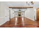 Spacious living room features hardwood floors, a stone fireplace, and wood beam accents at 1298 Hines Rd, Clover, SC 29710