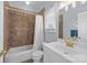 Cozy bathroom featuring tiled walls, a shower with a curtain, and a sink with brass fixtures at 13913 Queens Harbor Rd, Charlotte, NC 28278