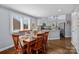 Bright dining area with hardwood floors and views into the kitchen at 13913 Queens Harbor Rd, Charlotte, NC 28278