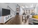 Bright living room with hardwood floors, skylights, and a cozy fireplace at 13913 Queens Harbor Rd, Charlotte, NC 28278