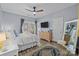 Light-filled main bedroom with hardwood floors, ceiling fan, and a view to a private outdoor space at 13913 Queens Harbor Rd, Charlotte, NC 28278