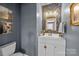 Stylish powder room with designer wallpaper and elegant fixtures at 13913 Queens Harbor Rd, Charlotte, NC 28278