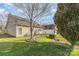 Well-maintained backyard featuring a lovely patio, mature trees, and green lawn, perfect for outdoor living at 14014 Acorn Creek Ln, Charlotte, NC 28269