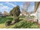 Well maintained backyard with green grass, mature trees and a patio with seating at 14014 Acorn Creek Ln, Charlotte, NC 28269