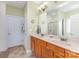 Bathroom featuring double sink vanity, neutral colors, and tile flooring at 14014 Acorn Creek Ln, Charlotte, NC 28269